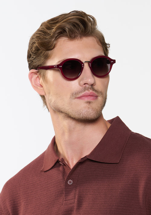 ASHTON | Brandy Silver Handcrafted, luxury burgundy acetate round KREWE sunglasses with silver stainless steel hardware mens model | Model: Linus