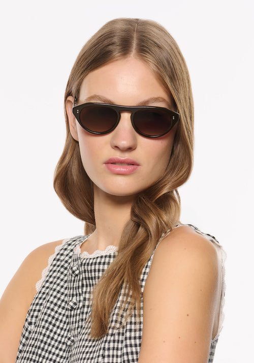BILLIE | Bronze Metallic + Bone Handcrafted, luxury dark brown acetate round aviator KREWE sunglasses womens model | Model: Isa