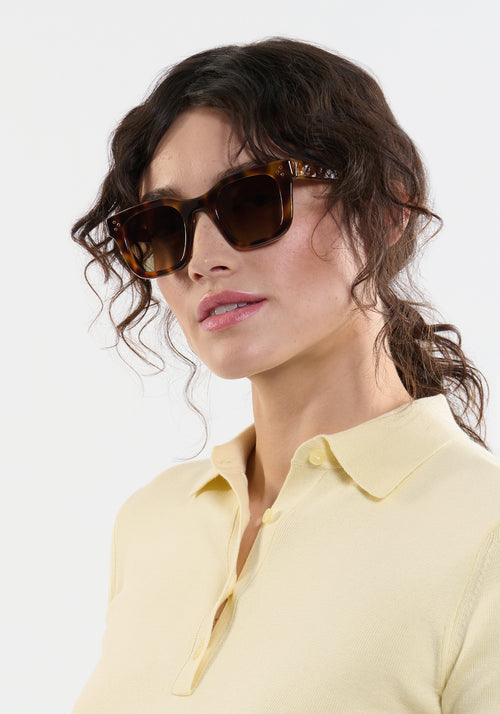 CELESTE | Handcrafted, luxury tortoise acetate medium sized square cat eye KREWE sunglasses womens model | Model: Ione