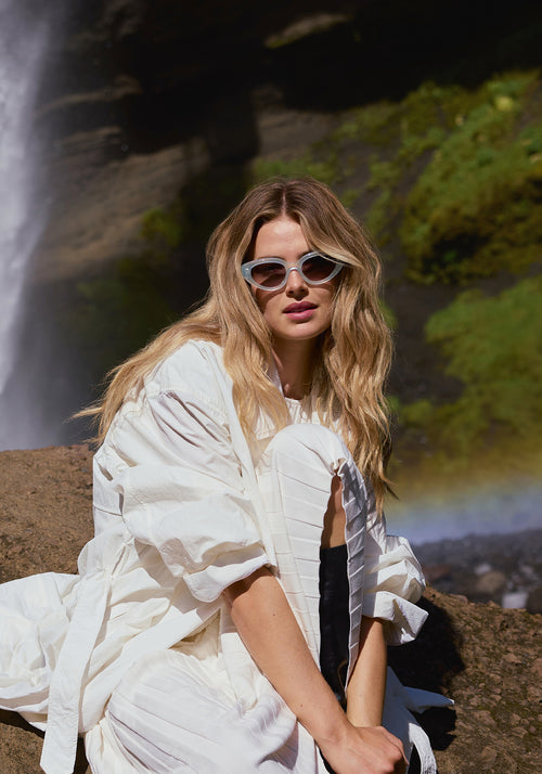 IRENE | Handcrafted, luxury powder blue acetate medium sized upswept oval wrap KREWE sunglasses womens model | Model: Frederique