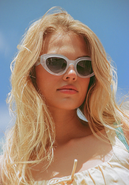 IRENE | Handcrafted, luxury powder blue acetate medium sized upswept oval wrap KREWE sunglasses womens model | Model: Chané