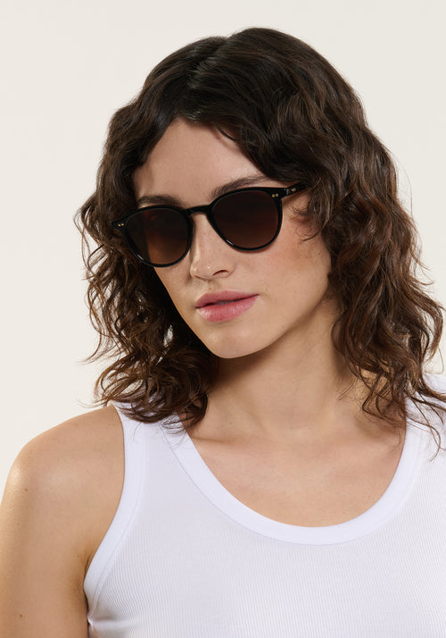 LANDRY | Black + Black Tea Handcrafted, luxury black acetate round KREWE sunglasses womens model | Model: Ione