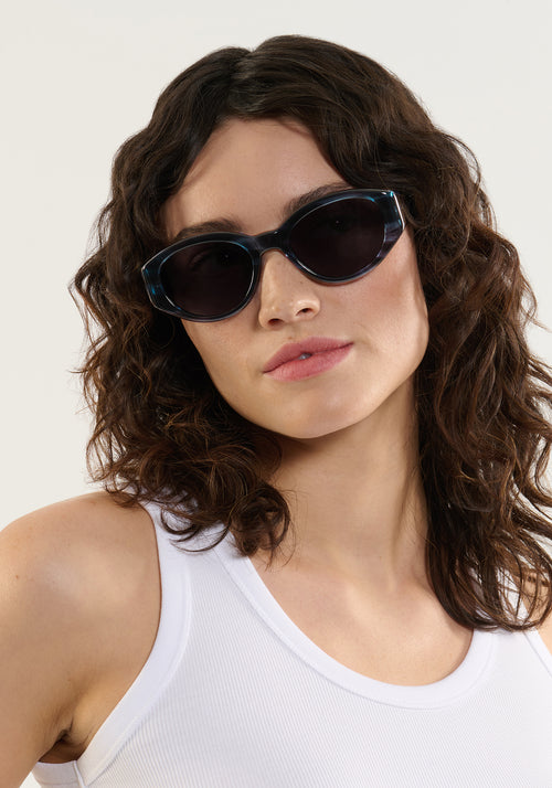 LUCY | Wake Handcrafted, luxury dark blue tortoise acetate medium sized oval wrap KREWE sunglasses womens model | Model: Ione