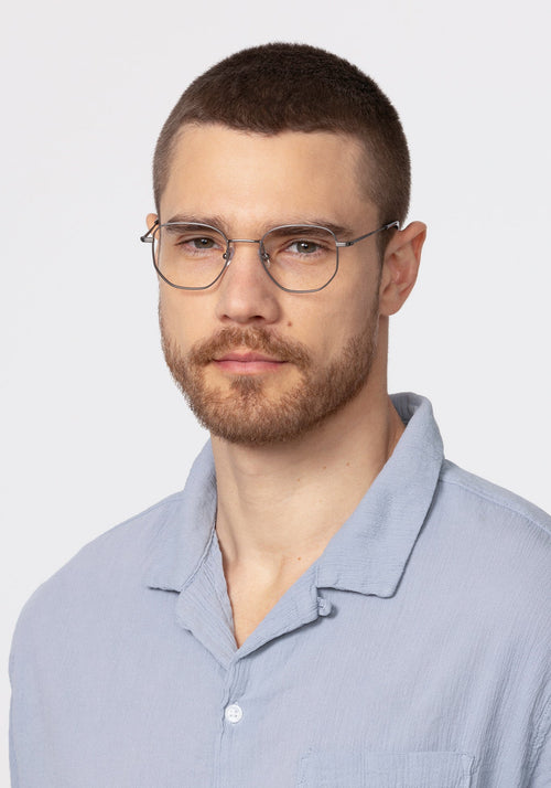 NELSON | Matte Raw Stainless Steel + Denim Handcrafted, luxury stainless steel oversized geometric round KREWE eyeglasses mens model | Model: David
