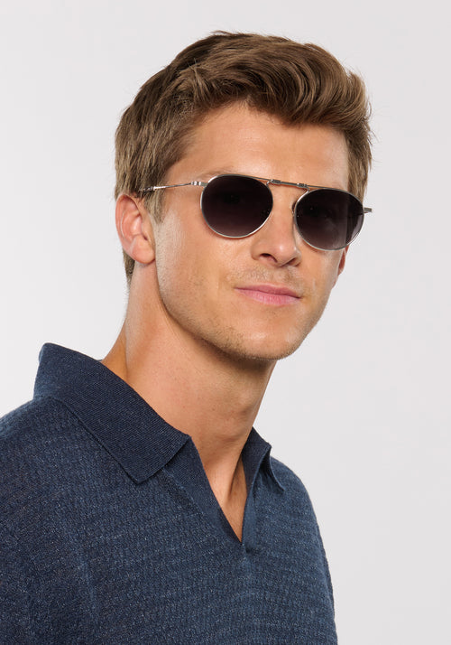 RAMPART FOLD | Silver + Nightfall Handcrafted, luxury stainless steel round folding aviator KREWE sunglasses mens model | Model: Ben