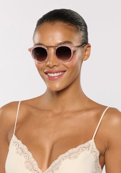 STL II | Fleur + Blush Tort 12K Handcrafted, large round light pink acetate and 12K gold metal bridge KREWE sunglasses womens model | Model: Sasha