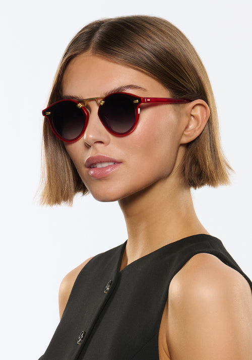 STL NYLON | Cherry 18K Handcrafted, luxury red cherry acetate round KREWE sunglasses with flat edge to edge nylon lens and 18k gold metal bridge women's model | Model: Michelle