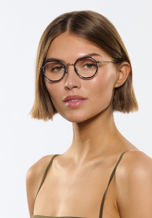 SIMON | Silver Titanium + Wake Handcrafted blue tortoise round geometric titanium and acetate KREWE eyeglasses women's model | Model: Michelle