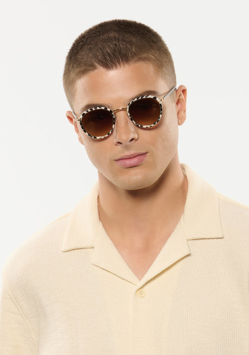 TATE | Domino 18K Handcrafted, luxury black and white spotted acetate and stainless steel small round KREWE sunglasses mens model | Model: Joey
