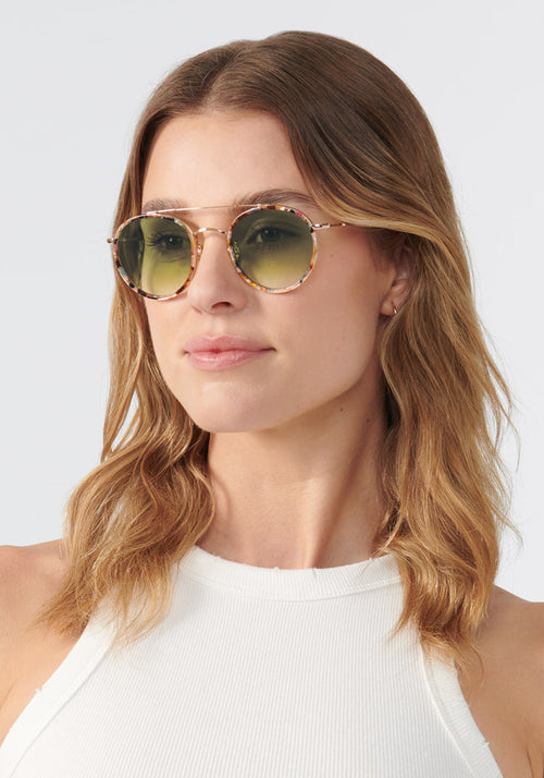 KREWE SUNGLASSES - PORTER | 18K Titanium + Capri + Petal + Custom Vanity Tint handcrafted luxury round colorful sunglasses with green tinted lenses womens model | Model: Keke