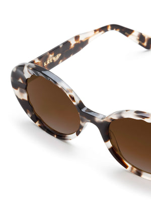 Tortoiseshell acetate sunglasses with brown gradient lenses and "KREW" branding on the arms.