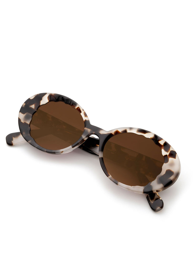Tortoiseshell round sunglasses with brown tinted lenses and black acetate frames.