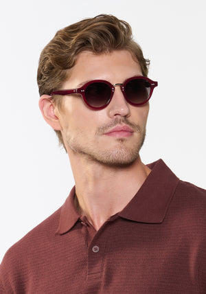 ASHTON | Brandy Silver Handcrafted, luxury burgundy acetate round KREWE sunglasses with silver stainless steel hardware mens model | Model: Linus
