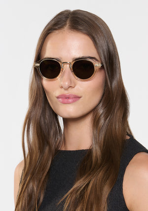 ASHTON | Haze + Iberia 12K Polarized Handcrafted polarized, luxury champagne pearlescent acetate round KREWE sunglasses with gold stainless steel metal hardware womens model | Model: Sam
