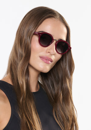 ASHTON | Brandy Silver Handcrafted, luxury burgundy acetate round KREWE sunglasses with silver stainless steel hardware womens model | Model: Sam