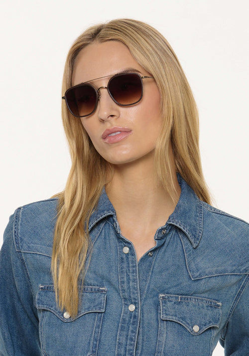 AUSTIN | Antique Gold Titanium + Brown Leather Handcrafted, luxury dark brown acetate and titanium aviator KREWE sunglasses womens model | Model: Isabelle