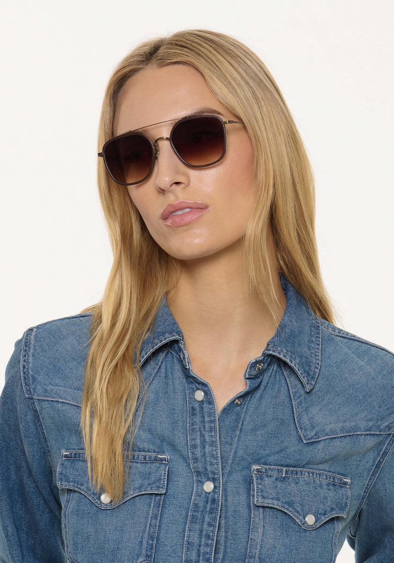 AUSTIN | Antique Gold Titanium + Brown Leather Handcrafted, luxury dark brown acetate and titanium aviator KREWE sunglasses womens model | Model: Isabelle