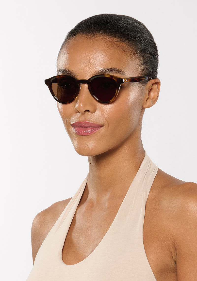 BARRETT | Havana Handcrafted, luxury brown tortoise acetate round KREWE sunglasses womens model | Model: Sasha