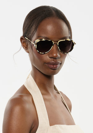 COLEMAN BLINKER | Bone 12K Handcrafted, luxury white and grey tortoise acetate large aviator KREWE sunglasses with blinkers womens model | Model: Brenda