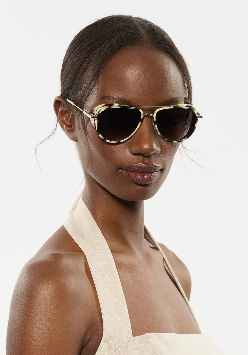 COLEMAN BLINKER | Bone 12K Handcrafted, luxury white and grey tortoise acetate large aviator KREWE sunglasses with blinkers womens model | Model: Brenda