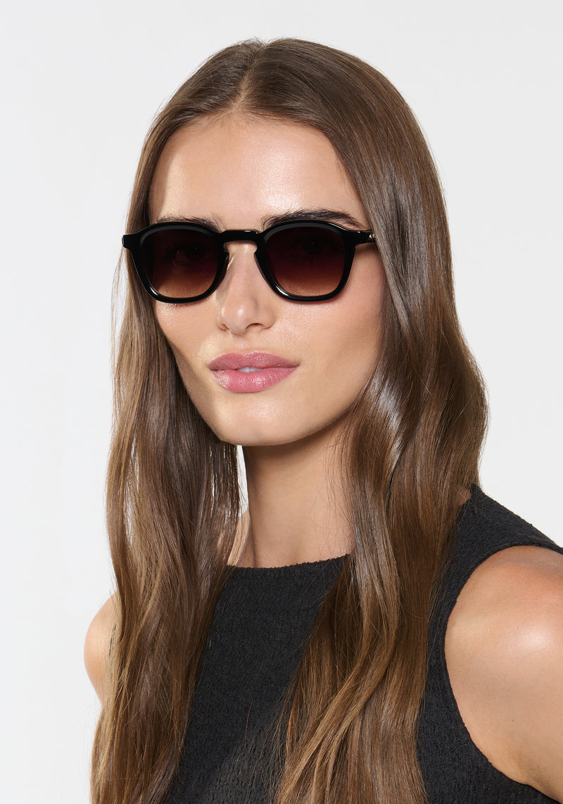 DYLAN | Black + Black Tea Handcrafted, luxury black acetate square classic KREWE sunglasses womens model | Model: Sam
