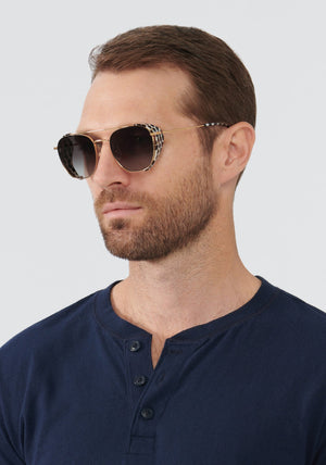 EARHART BLINKER | Matte Black + 24K Domino Handcrafted, luxury black and white spotted acetate KREWE sunglasses mens model | Model: Vince