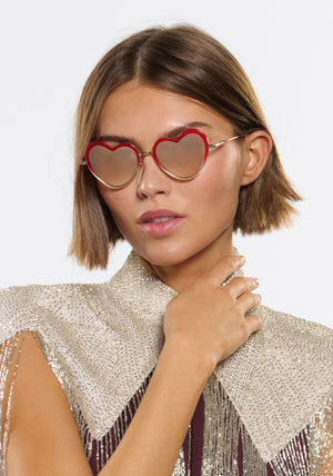 FAITHFUL | 18K + Cherry on Top Handcrafted, luxury, heart shaped red Mardi Gras acetate and 18K stainless steel KREWE sunglasses womens model | Model: Michelle