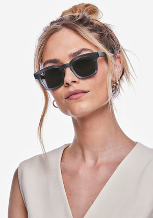 HARRISON | Matte Denim Handcrafted, matte dark blue navy acetate square KREWE sunglasses womens model | Model: Meghan