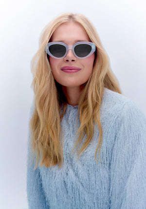 IRENE | Handcrafted, luxury powder blue acetate medium sized upswept oval wrap KREWE sunglasses womens model | Model: Emily U.