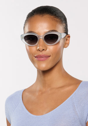 IRENE | Handcrafted, luxury powder blue acetate medium sized upswept oval wrap KREWE sunglasses womens model | Model: Sasha