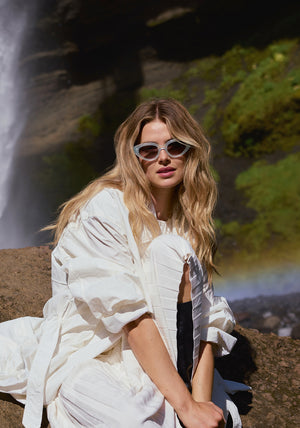 IRENE | Handcrafted, luxury powder blue acetate medium sized upswept oval wrap KREWE sunglasses womens model | Model: Frederique