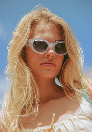 IRENE | Handcrafted, luxury powder blue acetate medium sized upswept oval wrap KREWE sunglasses womens model | Model: Chané