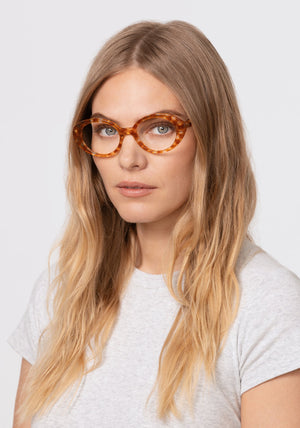 LAUREL | Amaretto Handcrafted, luxury dark brown checkered acetate round oval KREWE eyeglasses womens model | Model: Maritza