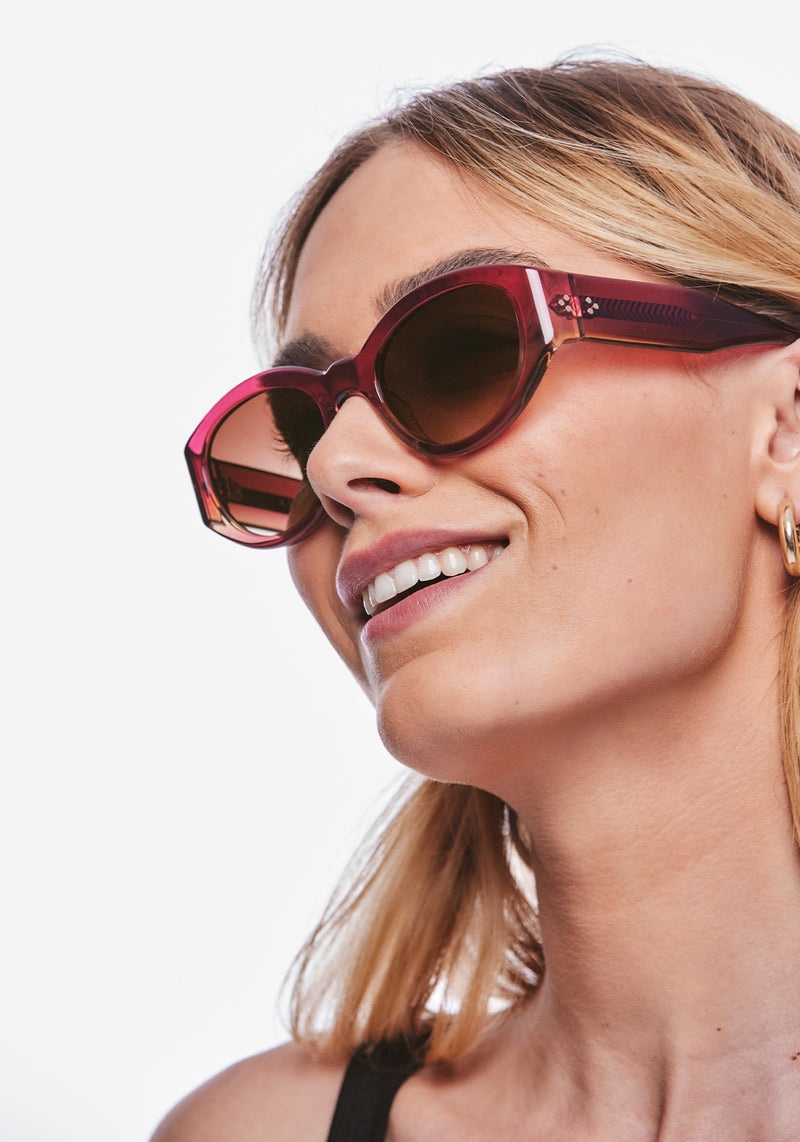 LUCY | Hibiscus Handcrafted, luxury dark pink gradient acetate medium sized oval wrap KREWE sunglasses womens model | Model: Meghan