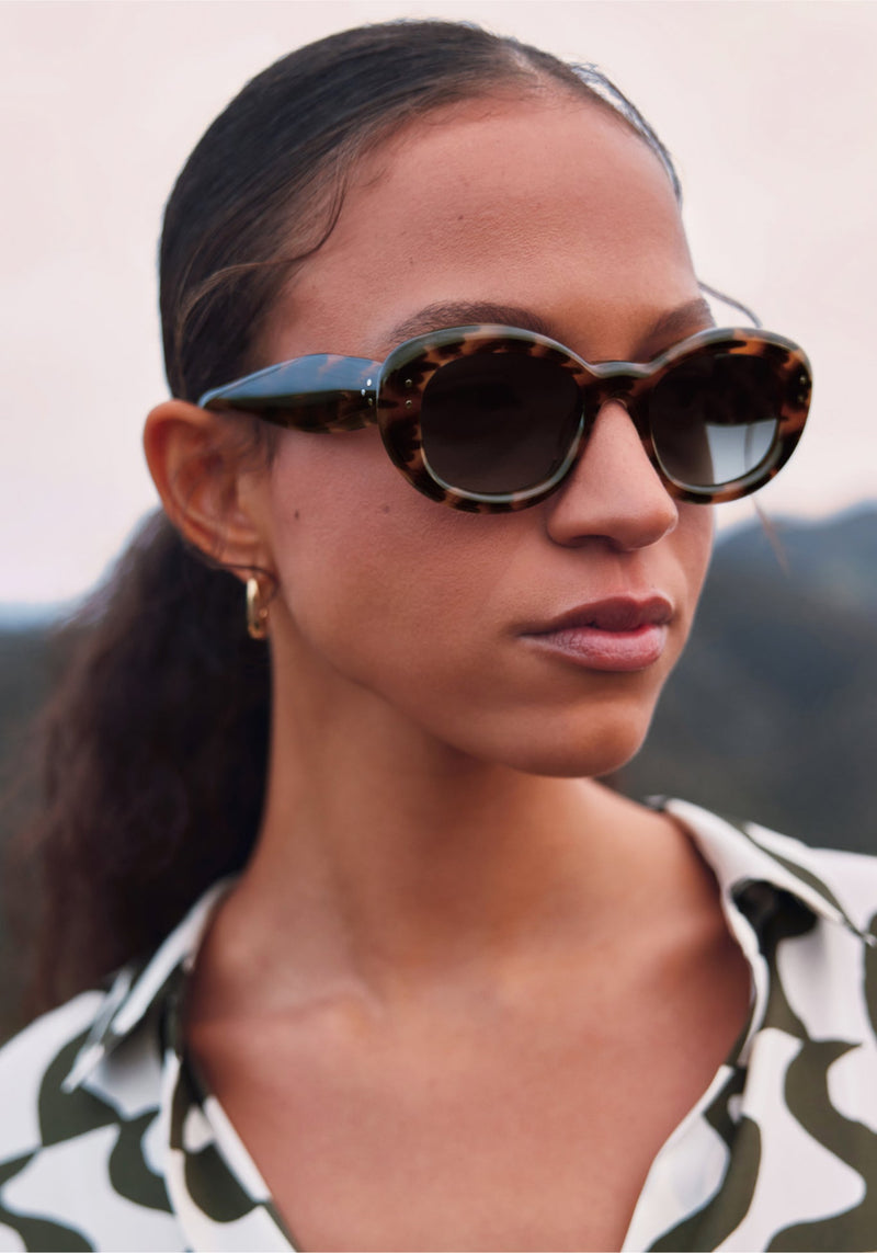 MARGARET | Venezia Handcrafted, luxury dark brown and black tortoise acetate medium sized oval bubble frame KREWE sunglasses womens model campaign | Model: Morgan