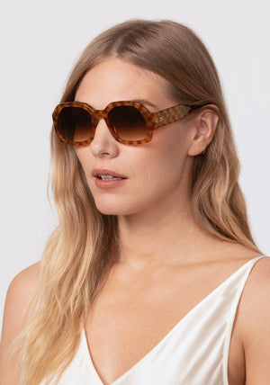 NAOMI | Fernet Handcrafted, luxury brown checkered tortoise acetate oversized geometric wrap KREWE sunglasses womens model | Model: Maritza