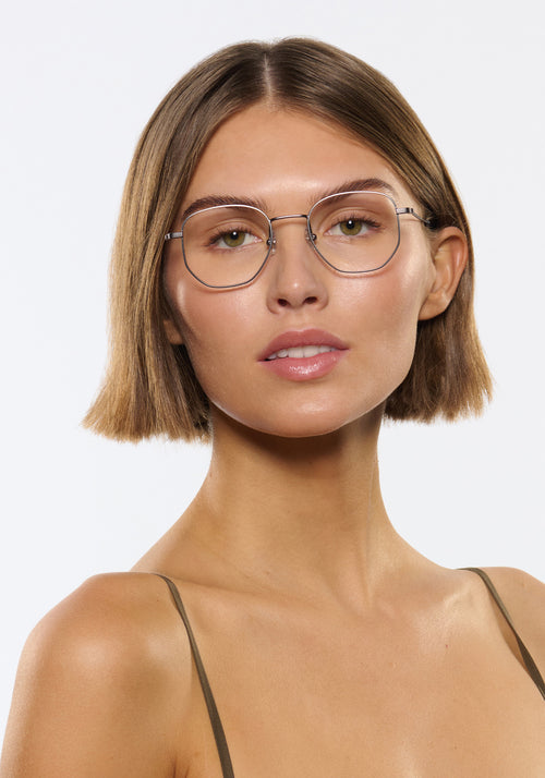 NELSON | Matte Raw Stainless Steel + Denim Handcrafted, luxury stainless steel oversized geometric round KREWE eyeglasses womens model | Model: Michelle