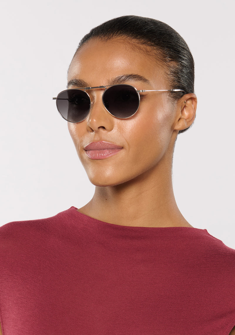 RAMPART FOLD | Silver + Nightfall Handcrafted, luxury stainless steel round folding aviator KREWE sunglasses womens model | Model: Sasha