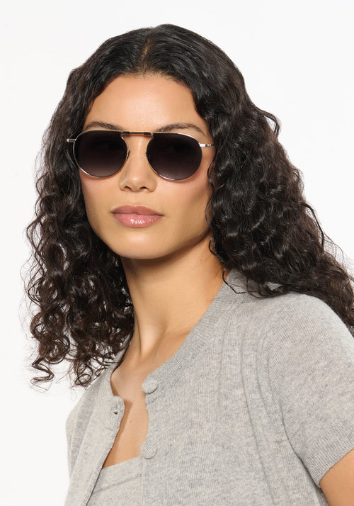 RAMPART FOLD | Silver + Nightfall Handcrafted, luxury stainless steel round folding aviator KREWE sunglasses womens model | Model: Jessika