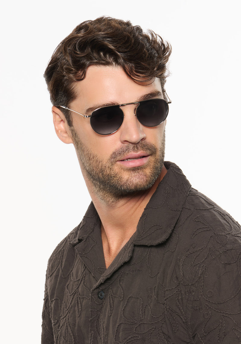 RAMPART FOLD | Silver + Nightfall Handcrafted, luxury stainless steel round folding aviator KREWE sunglasses mens model | Model: Ryan A.