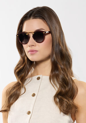 STL II | Espresso 18K Handcrafted, large round luxury dark brown acetate and 18K gold metal bridge KREWE sunglasses womens model | Model: Kennidy
