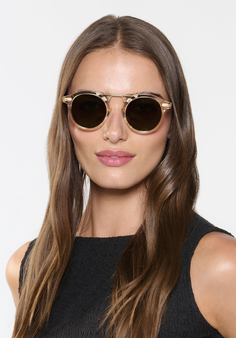 STL II | Haze + Iberia 12K Polarized Handcrafted, large round luxury champagne pearlescent acetate and 12K gold metal bridge KREWE sunglasses womens model | Model: Sam