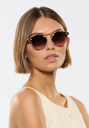 STL NYLON | Matte Blush Tort 18K Handcrafted, luxury pink and brown tortoise acetate round KREWE sunglasses with flat edge to edge nylon lens and 18k gold metal bridge womens model | Model: Michelle