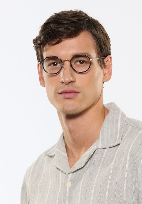 SIMON | Silver Titanium + Wake Handcrafted blue tortoise round geometric titanium and acetate KREWE eyeglasses mens model | Model: Jegor