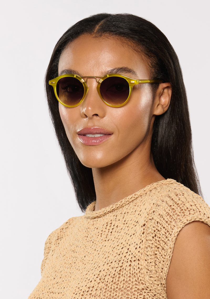 ST. LOUIS | Chartreuse 18K Handcrafted, luxury, yellow green acetate round KREWE sunglasses with gold bridge and hardware womens model campaign | Model: Sasha