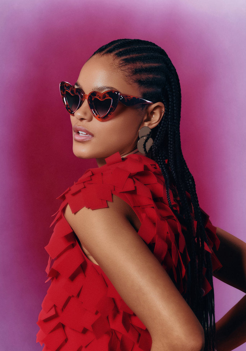 TEMPTRESS | Dirty Shirley Handcrafted, luxury red tortoise acetate oversized heart shaped Mardi Gras KREWE sunglasses womens model campaign | Model: May