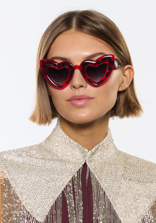 TEMPTRESS | Dirty Shirley Handcrafted, luxury red tortoise acetate oversized heart shaped Mardi Gras KREWE sunglasses womens model | Model: Michelle