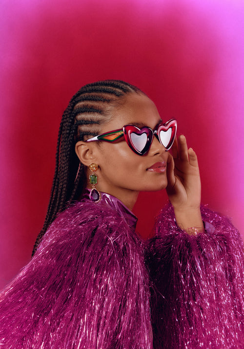 TEMPTRESS | Rouge + Royale Mirror Vanity (Float Edition) Handcrafted, luxury red acetate oversized heart shaped Mardi Gras KREWE sunglasses womens model campaign | Model: May