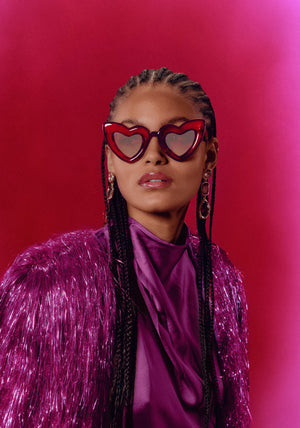 TEMPTRESS | Rouge + Royale Mirror Vanity (Float Edition) Handcrafted, luxury red acetate oversized heart shaped Mardi Gras KREWE sunglasses womens model campaign | Model: May