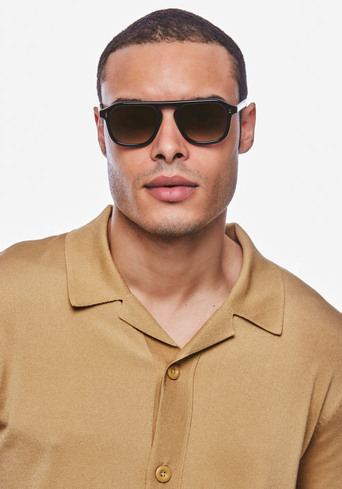 ZANDER | Black + Black Tea Handcrafted, luxury black acetate large rectangular aviator KREWE sunglasses mens model | Model: Jeffrey